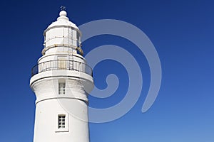 White lighthouse on a clear blue day